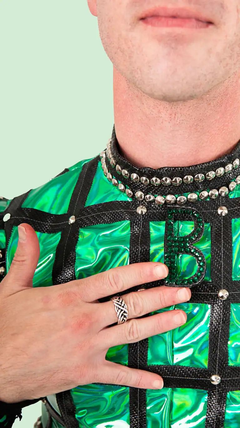 Designs Elijah's custom Anne Bolin costume from SIX the musical, close up of sparkly "B" necklace.