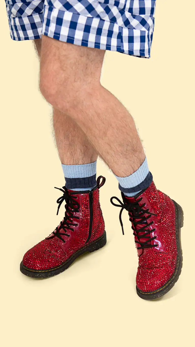 Designs Close up of Elijah's Dorothy costume featuring red combat boots with gemstones.