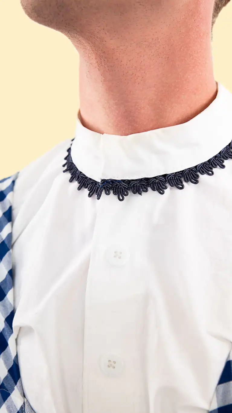 Designs Close up of Elijah's Dorothy costume for men, showing collar details.