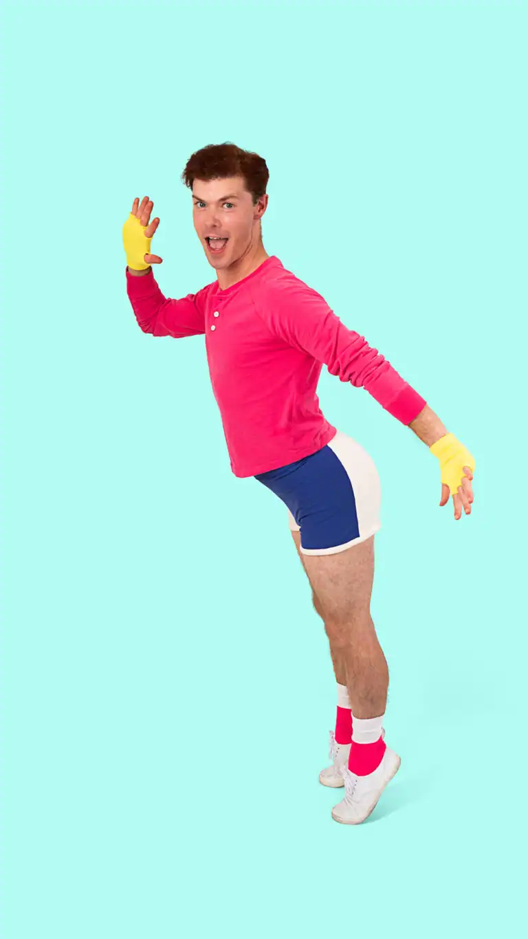 Designs Elijah's George Michael costume, posed in an active heel lift.