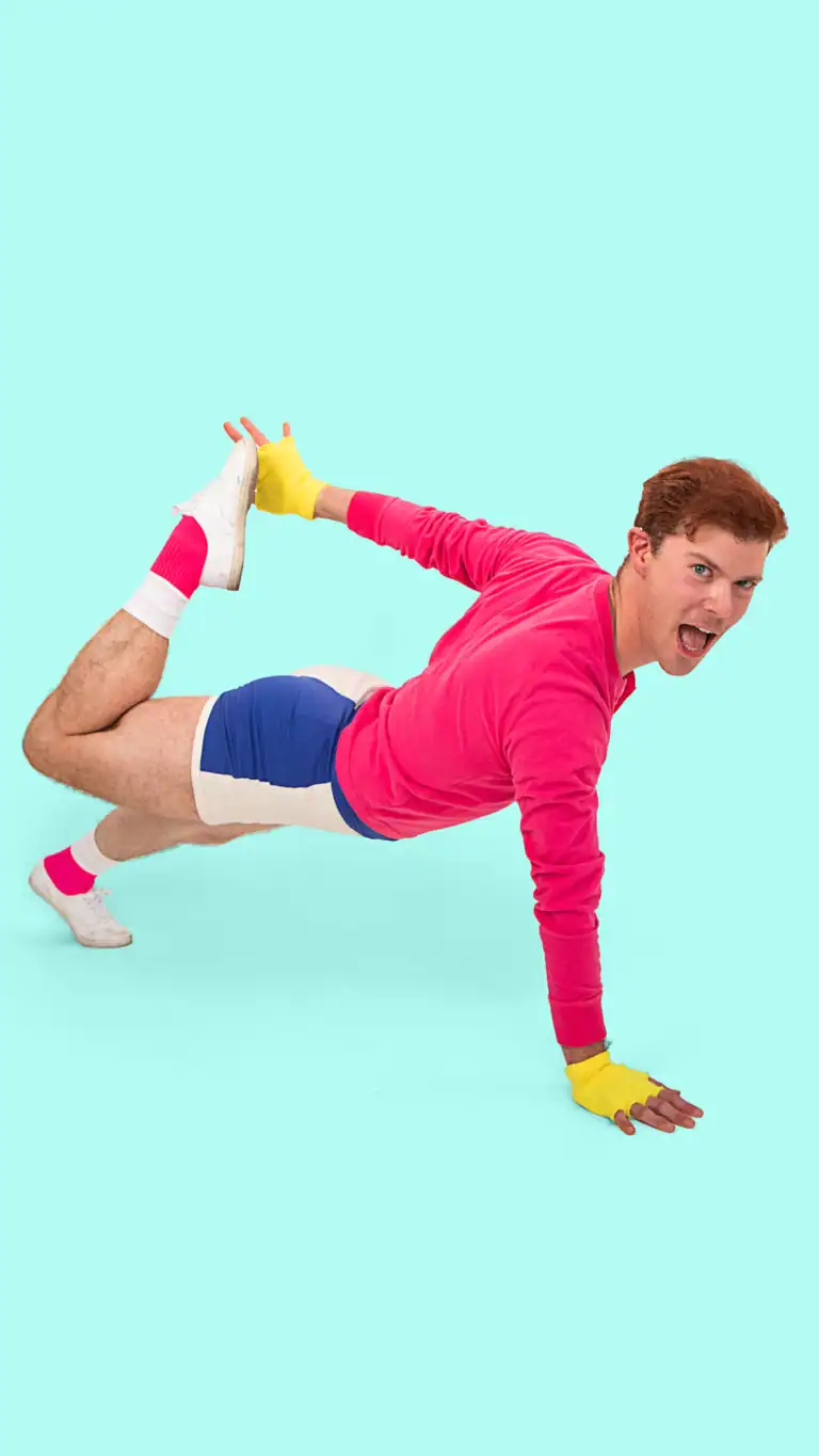 Designs Elijah's George Michael costume, posed in a workout plank.
