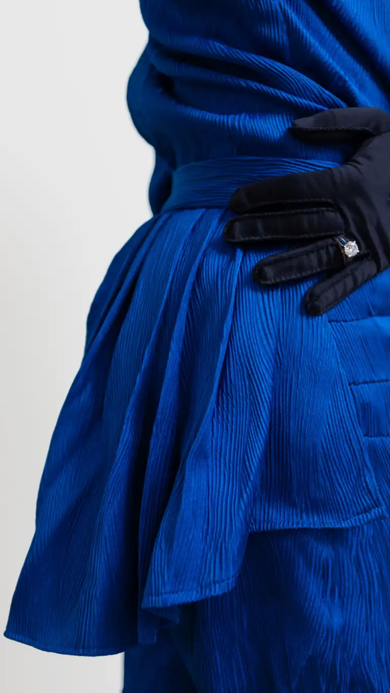 Designs Waist detail of Elijah's blue feminine mens fashion, with navy vintage gloves and ring on.
